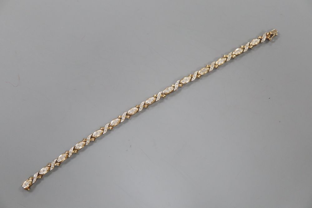 A modern 375 yellow metal and diamond chip set line bracelet, 18.9cm, gross 7.4 grams.